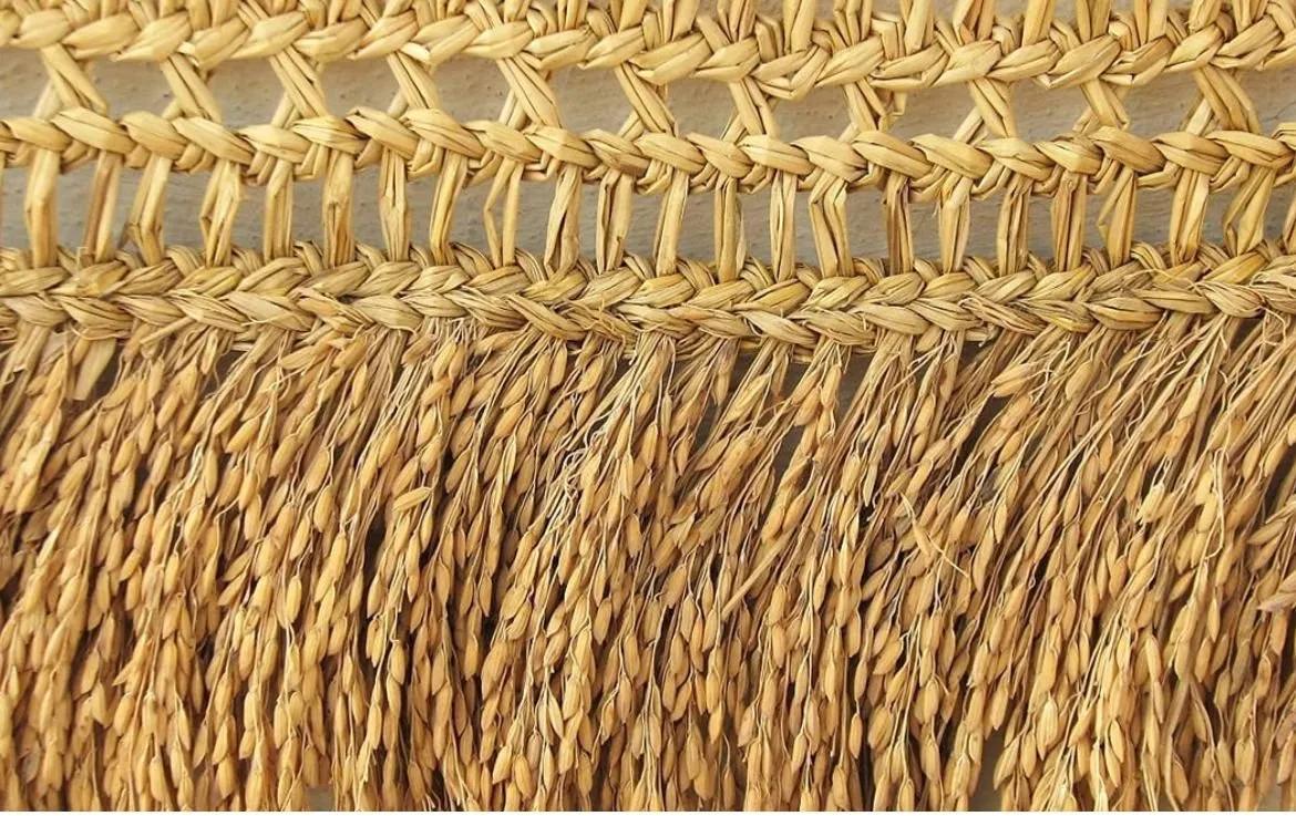 A golden paddy toran made of dried rice plants