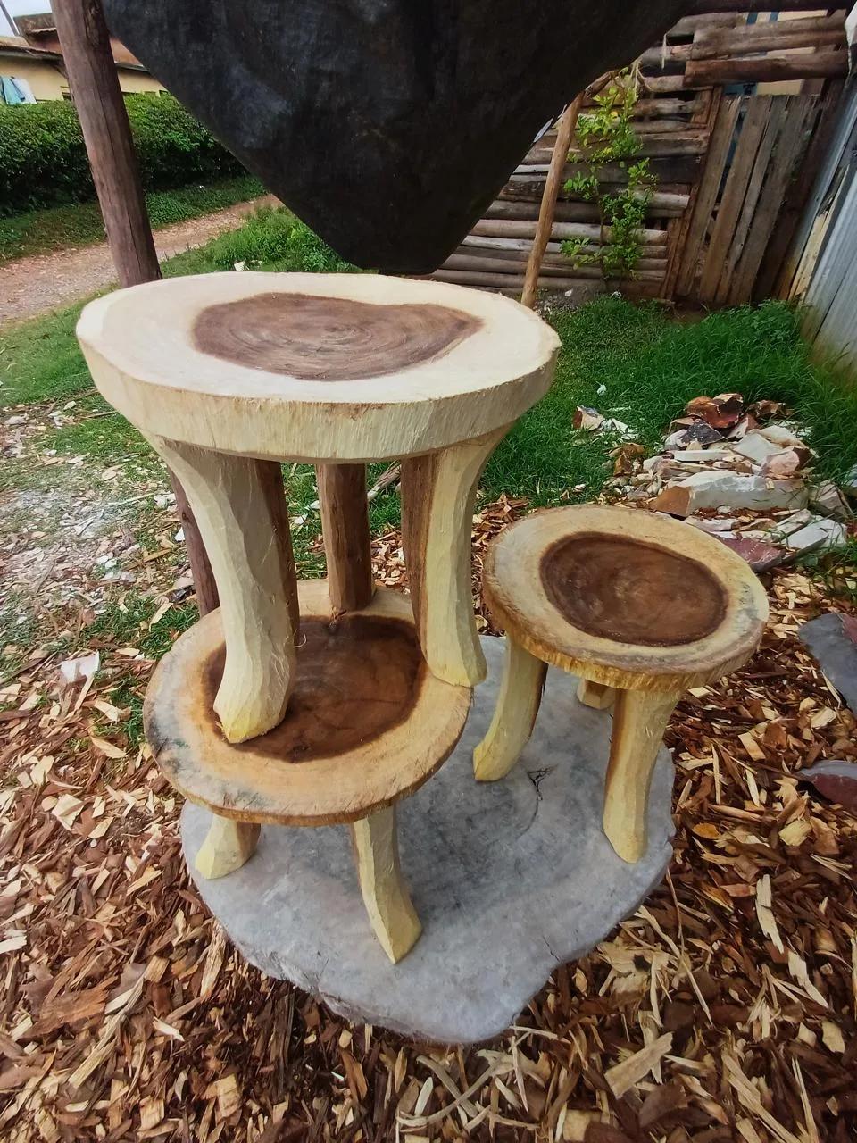 Hand-carved wooden stools in light and dark wood