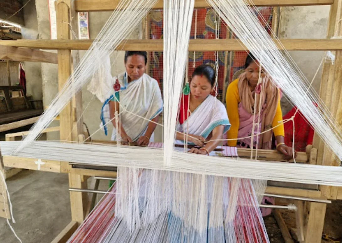 Three SNEHPAD weavers at a handloom in Upper Assam